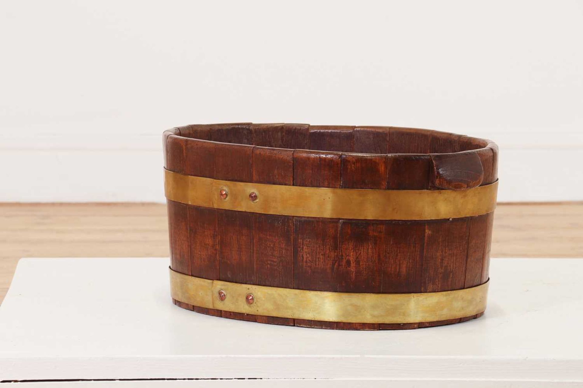 A coopered oak and brass planter or wine cooler,