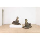 A pair of composition stone sphinxes in the manner of Austin & Seeley,