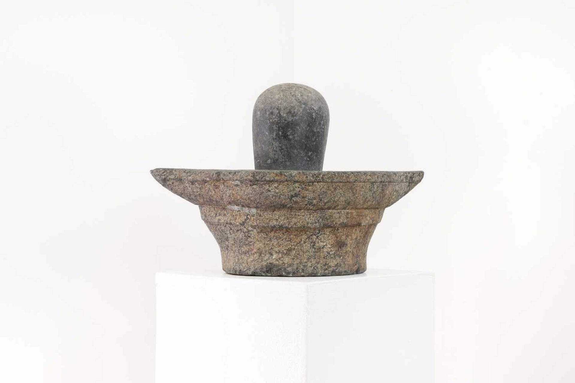 A carved granite lingam and yoni,