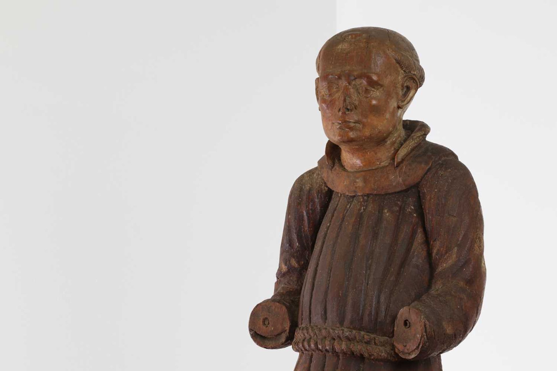 A carved walnut figure of a monk,