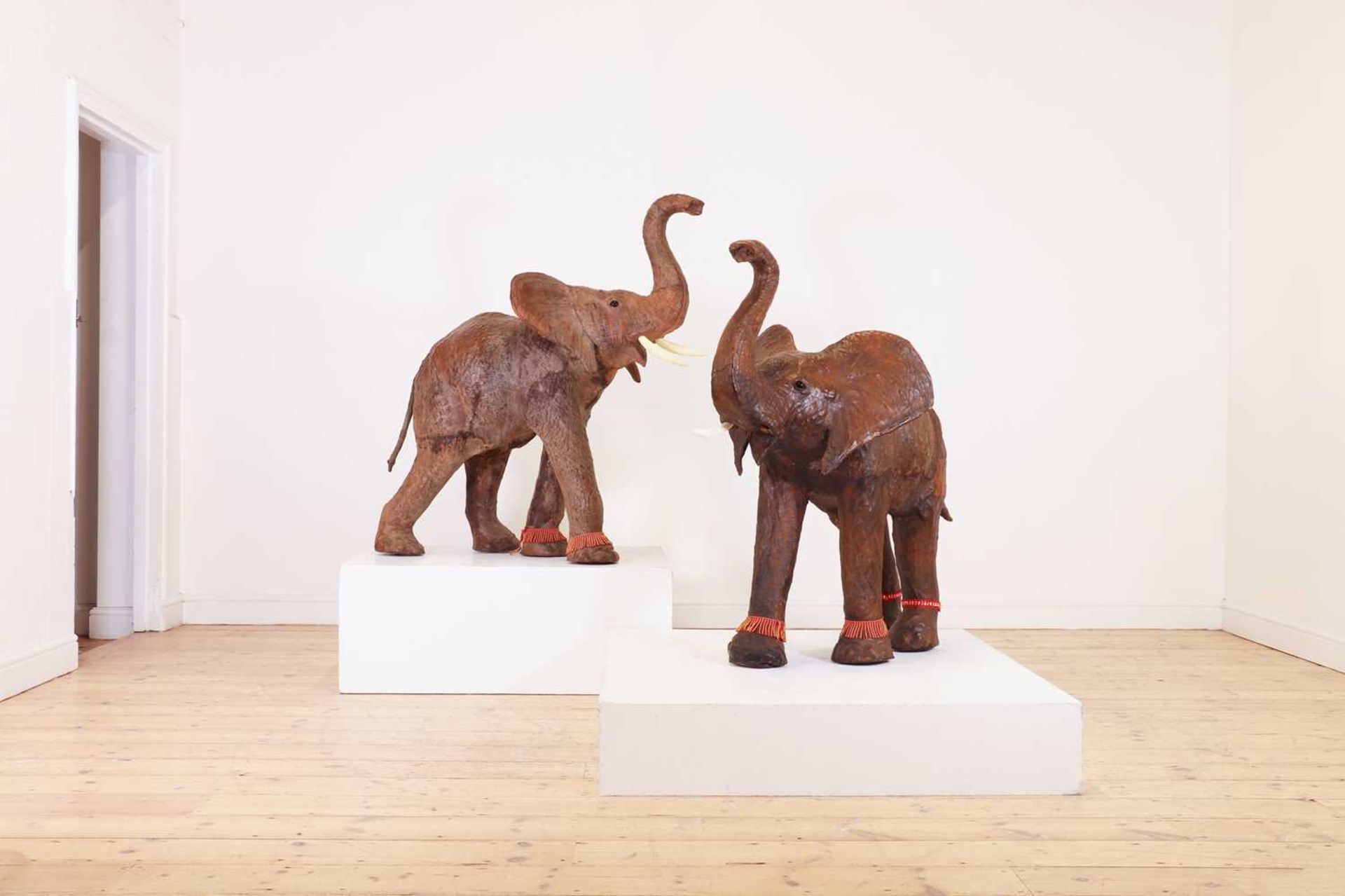 A near pair of leather elephants,