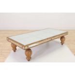 A mirrored glass and giltwood coffee table,