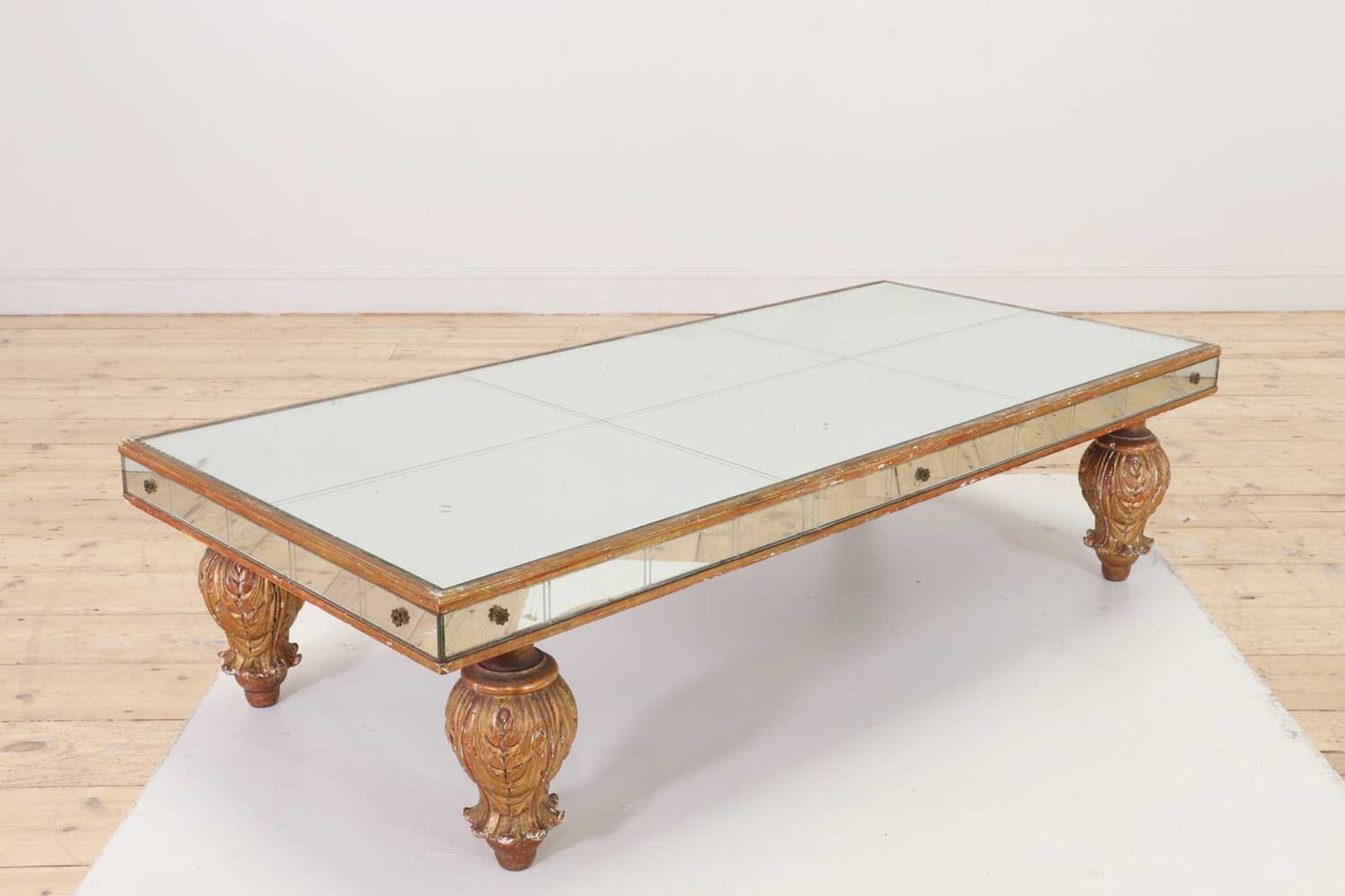 A mirrored glass and giltwood coffee table,