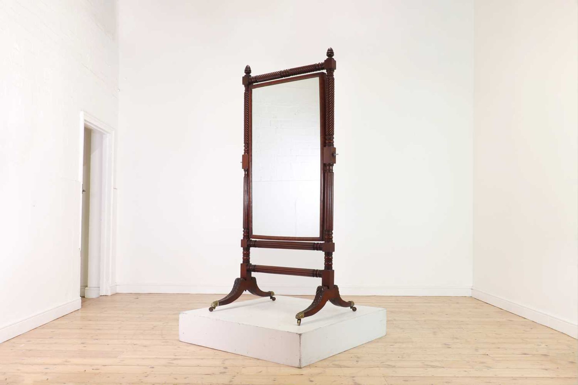 A large George IV mahogany cheval mirror in the manner of Gillows,
