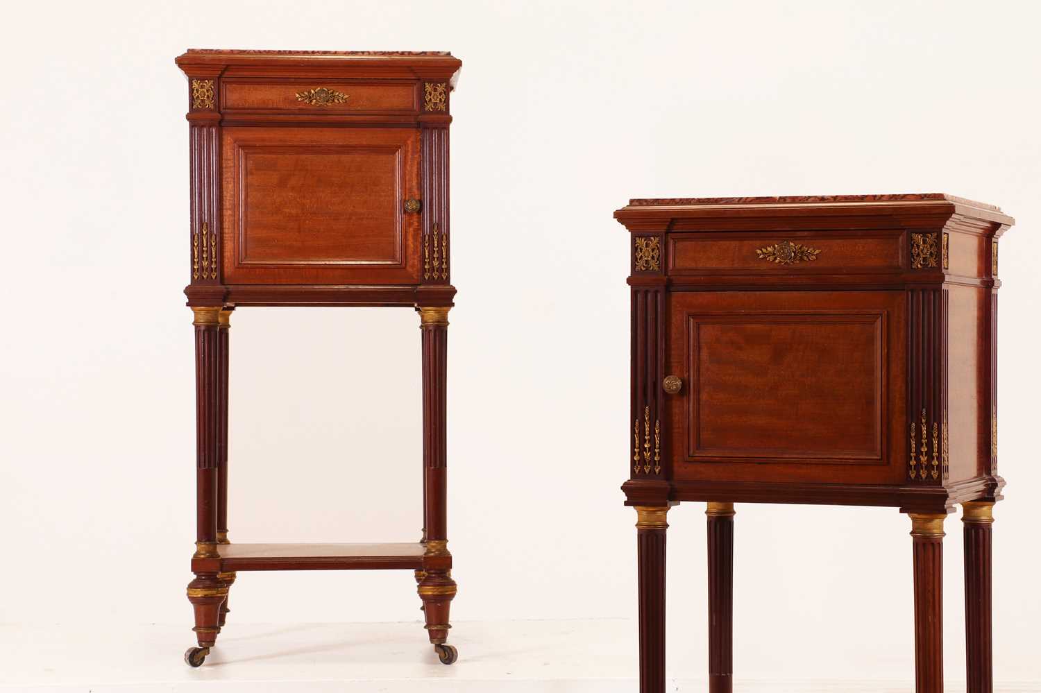 A pair of Directoire-style mahogany tables de nuit by Maison Krieger,