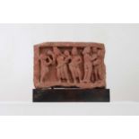 A carved red stone Mathura panel,