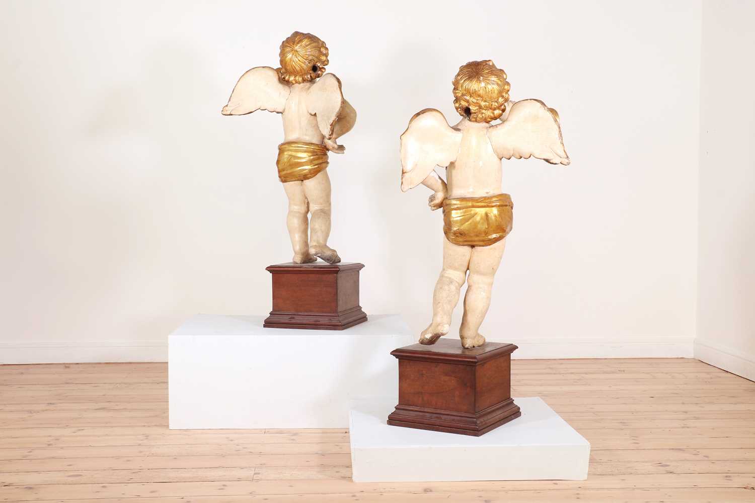 A pair of painted and parcel-gilt wooden putti, - Image 4 of 23