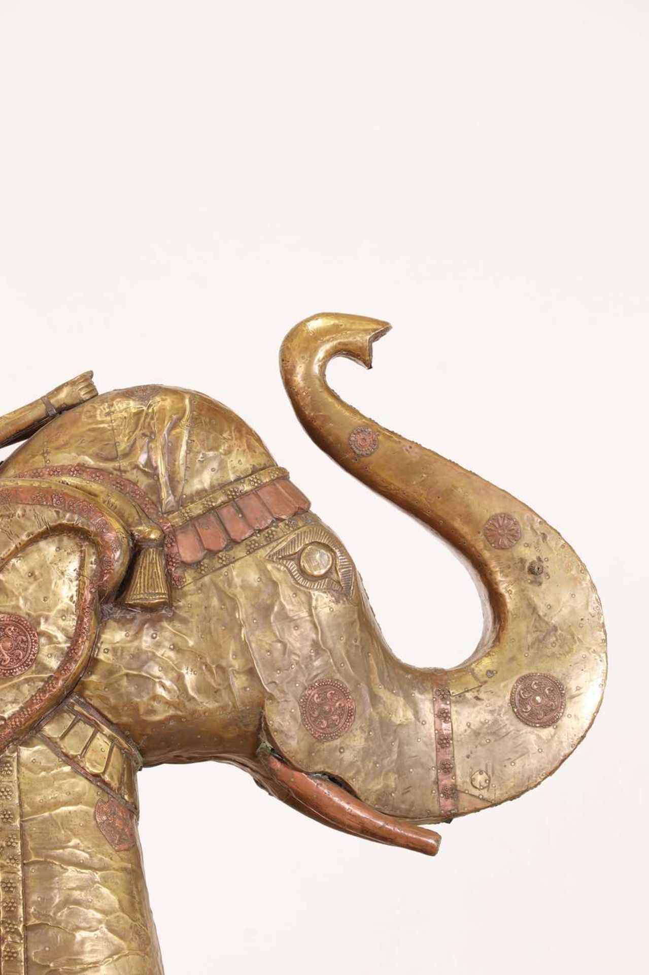 A large copper and brass-clad pull-along elephant,