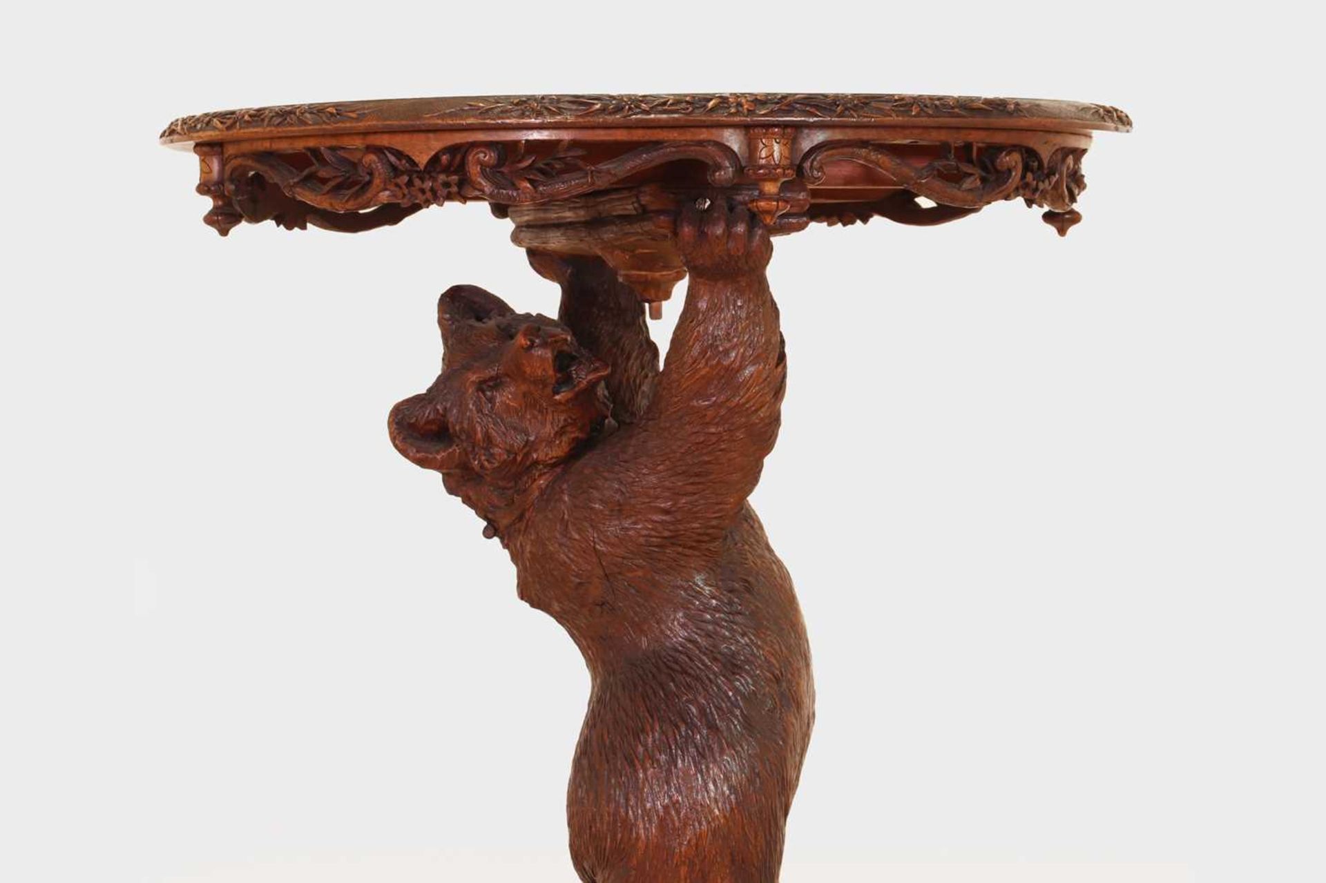 A Black Forest carved wood occasional table,