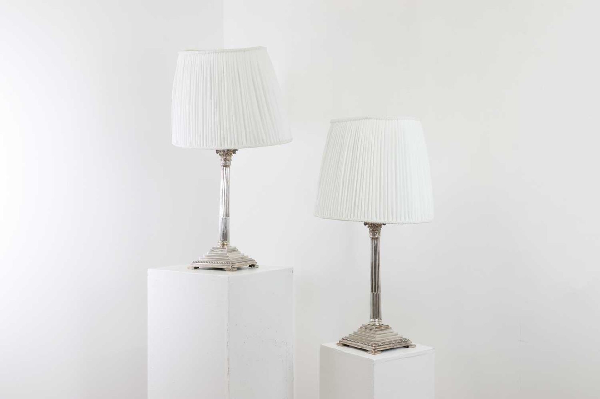 A pair of silver-plated table lamps,