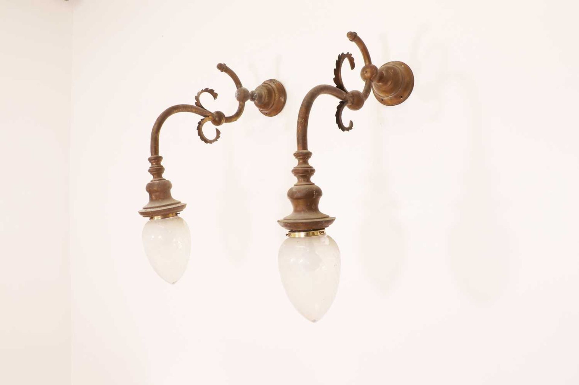 A pair of brass wall lights,