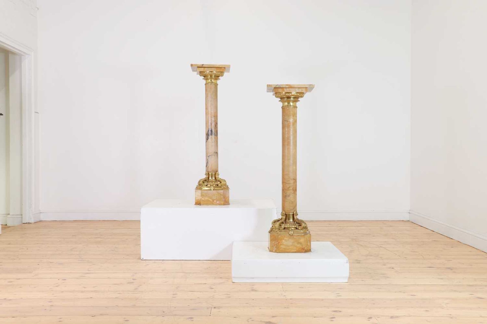 A pair of giallo antico marble pedestals,