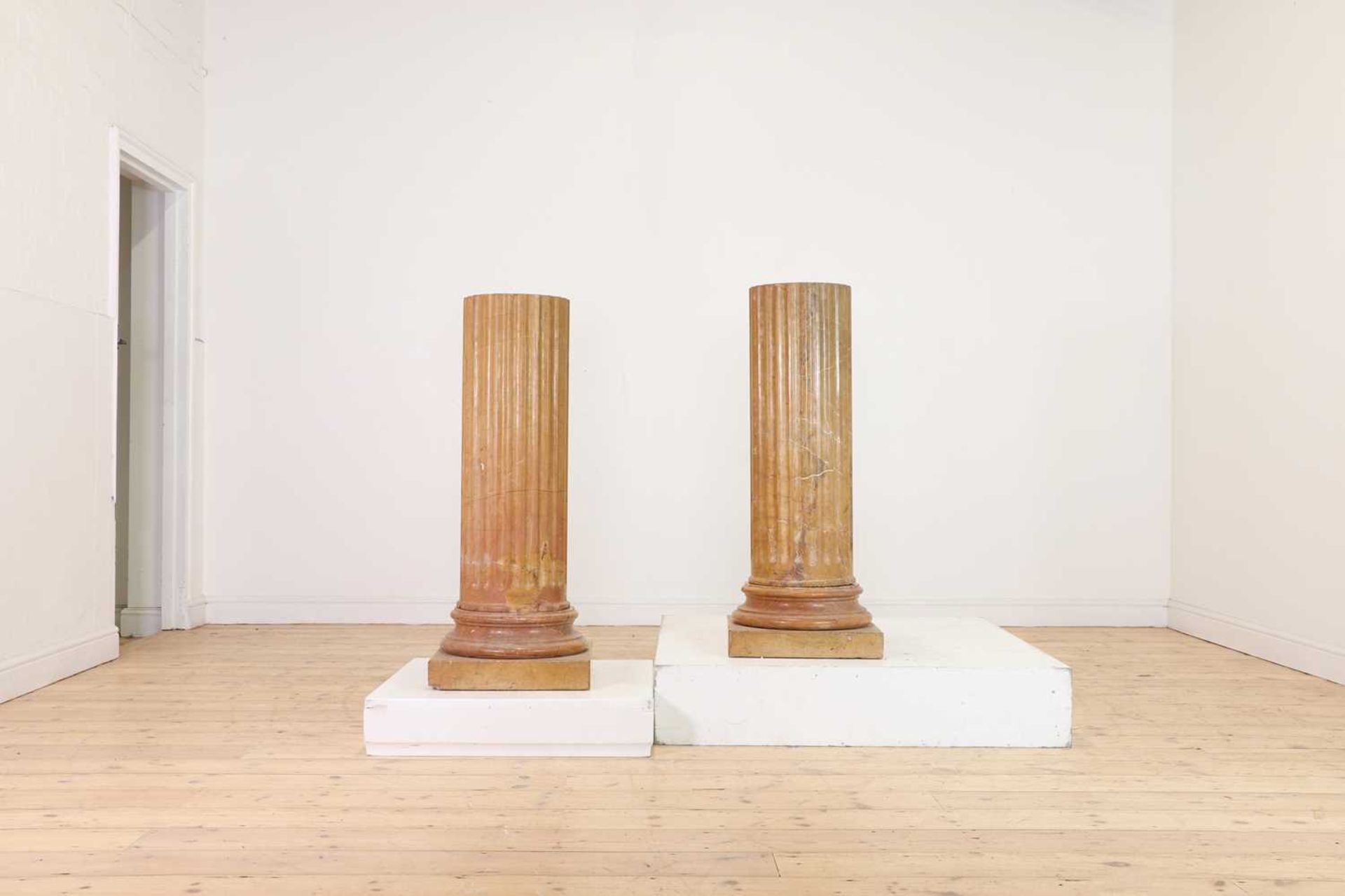 A pair of Siena-marble fluted columns,