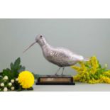 A silver-plated model of a woodcock or snipe,