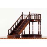 A turned wooden architectural model of a staircase,