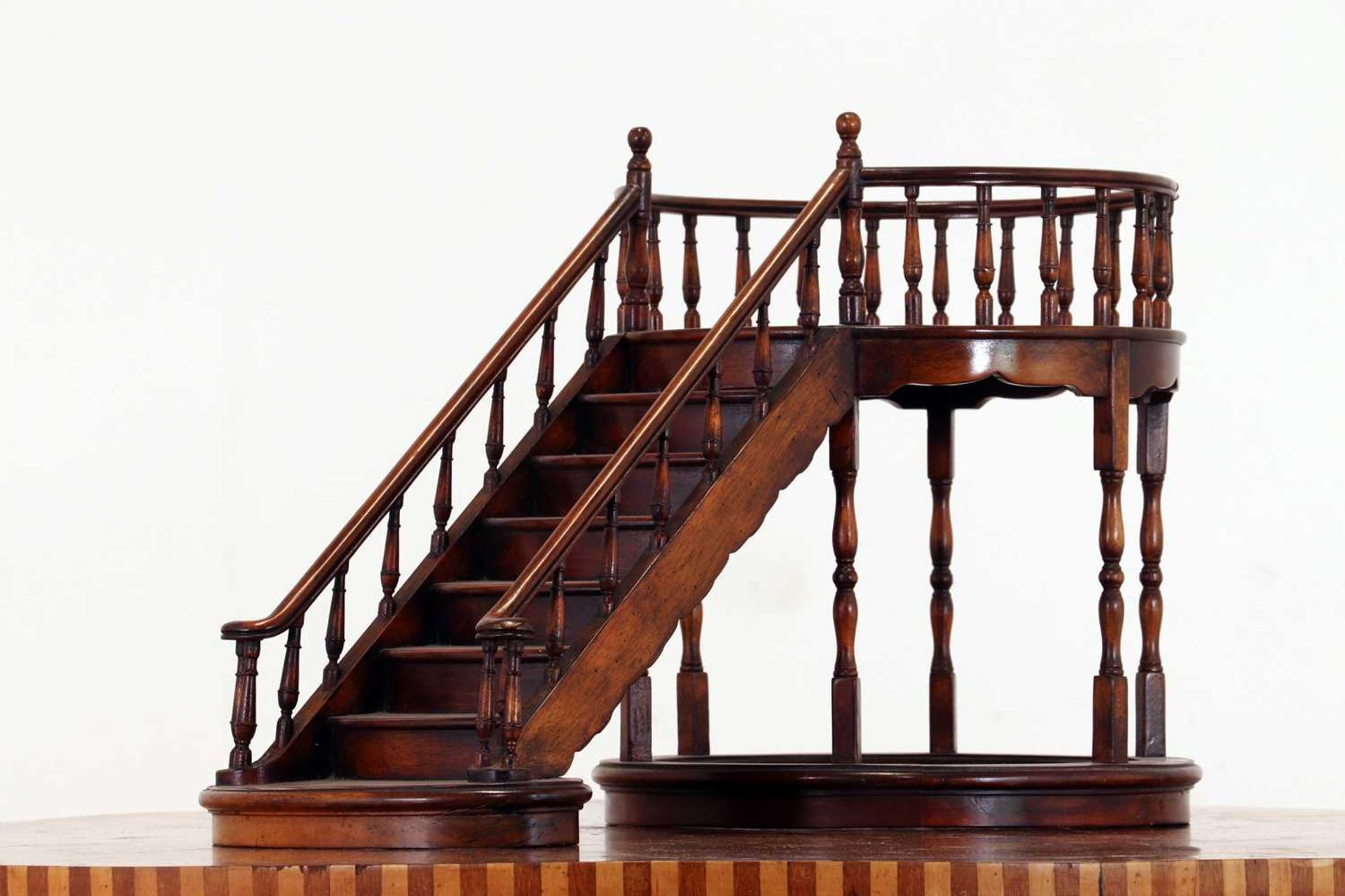 A turned wooden architectural model of a staircase,