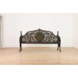 A large Victorian-style cast iron garden bench,