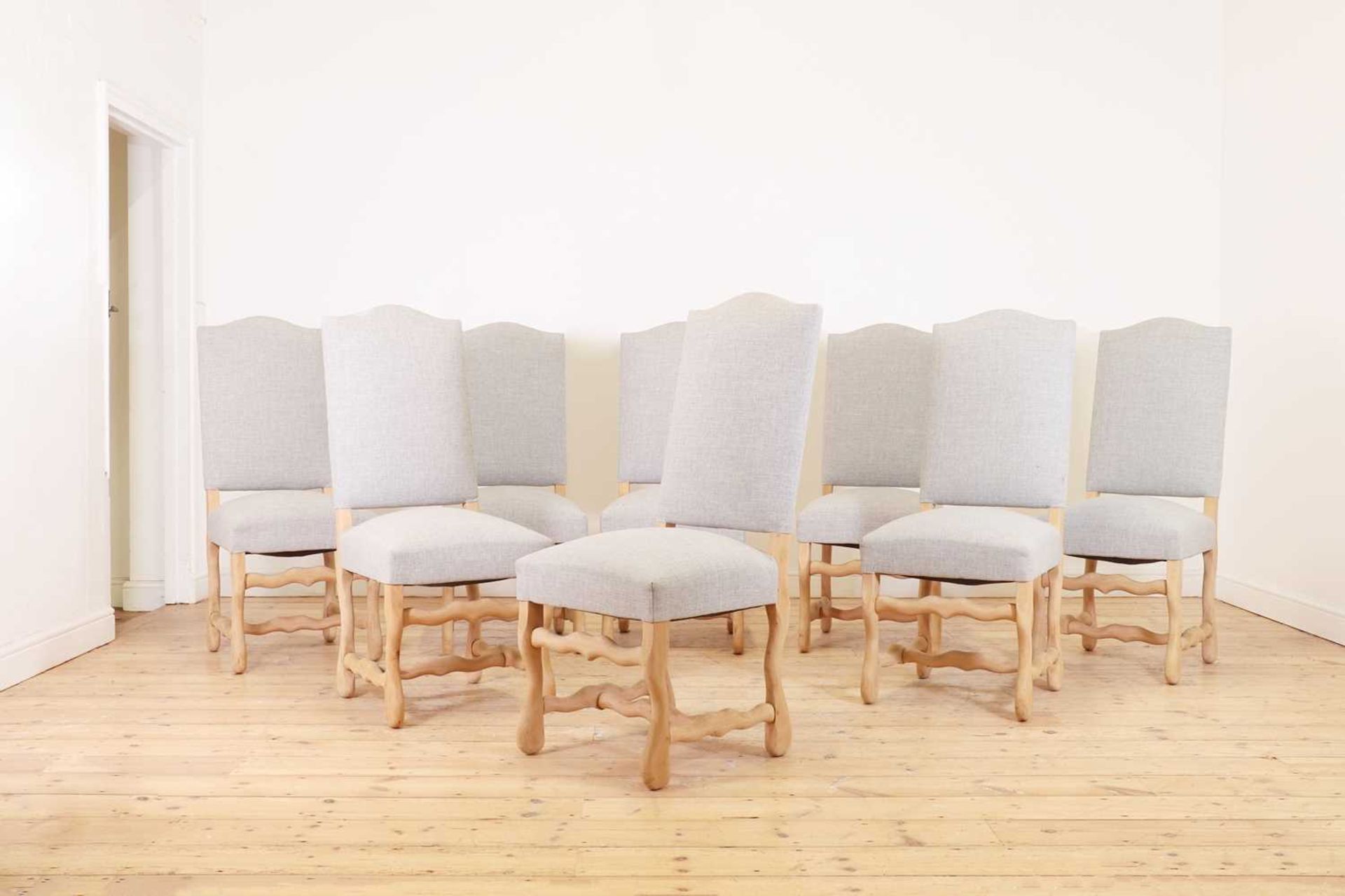 A set of eight stripped beech dining chairs,