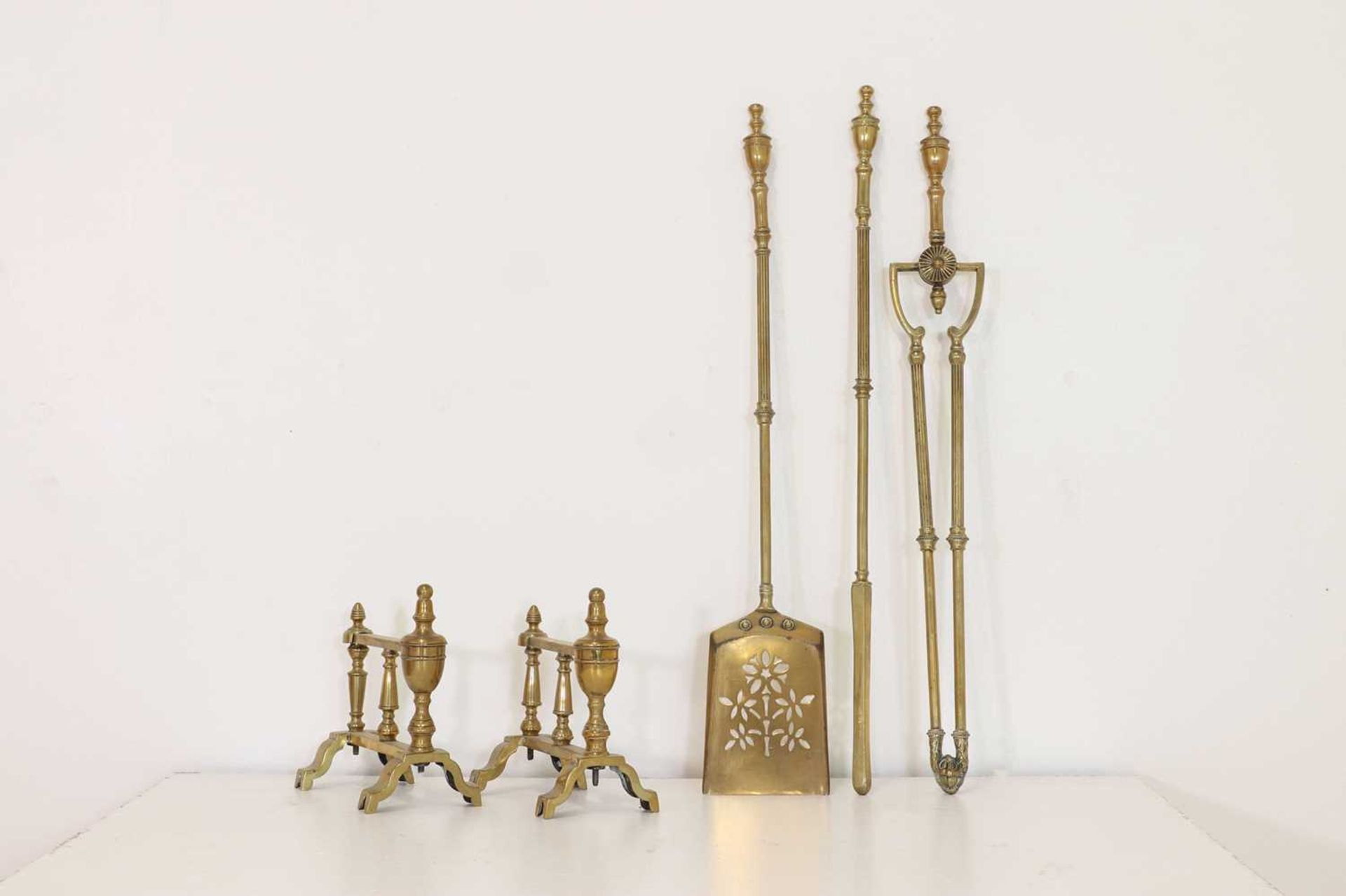 A set of brass fire tools,