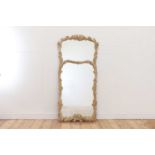 A carved wooden mirror in the Black Forest style,