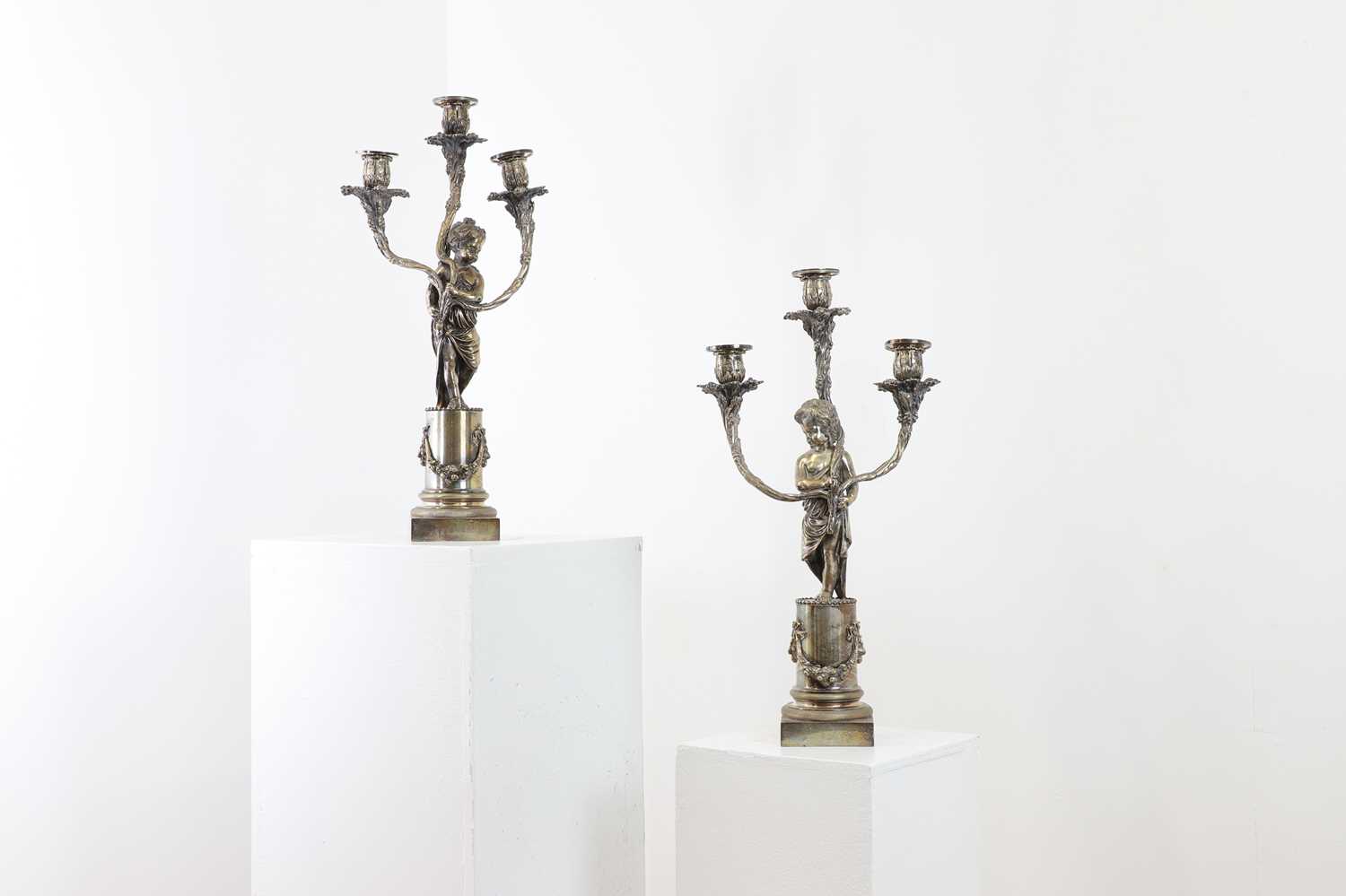 A pair of Louis XVI-style silver-plated candelabra,