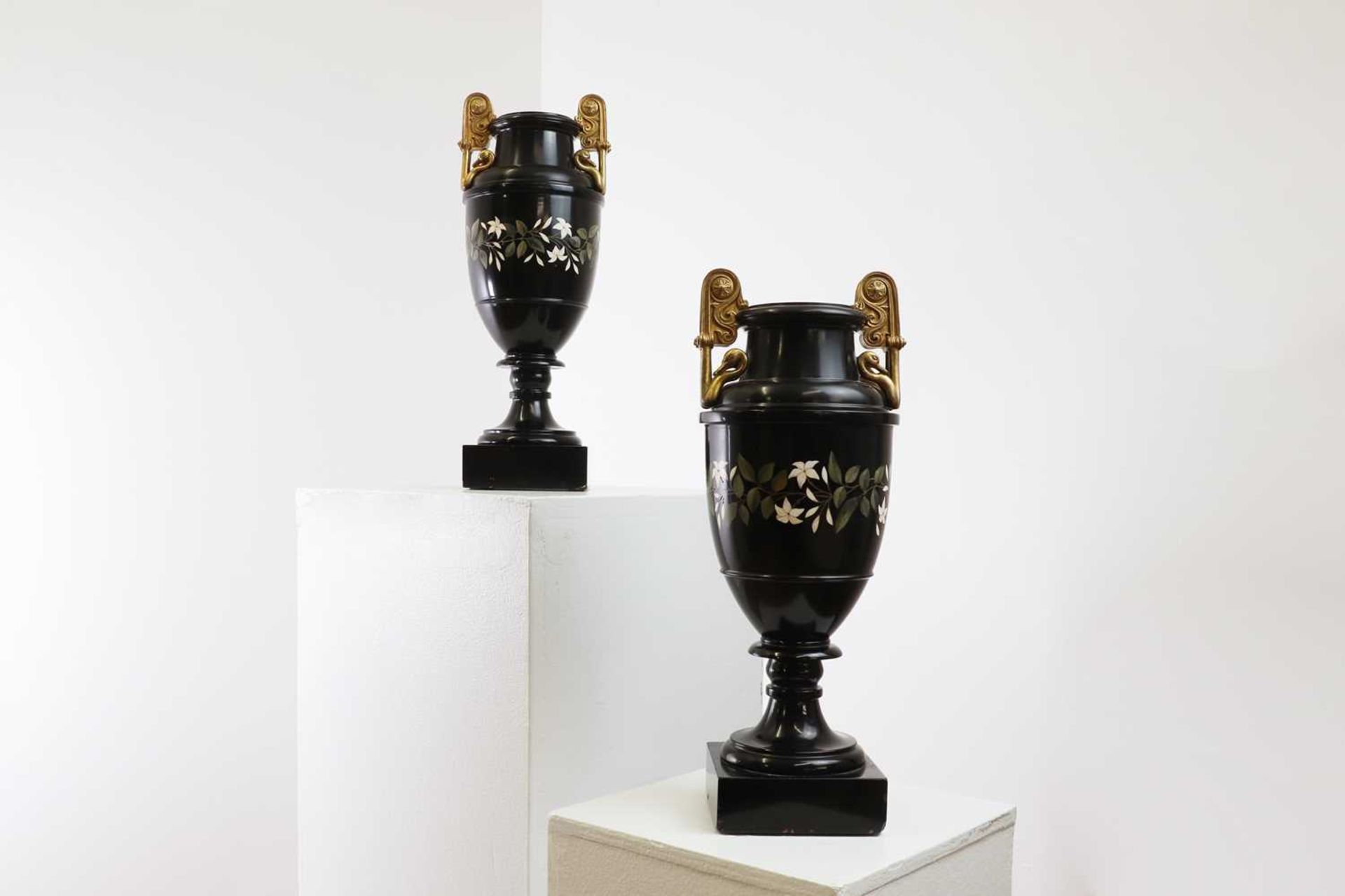 A pair of Ashford black marble urns,