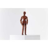A carved and stained pine artist's lay figure,