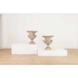 A pair of composite stone campana urns,