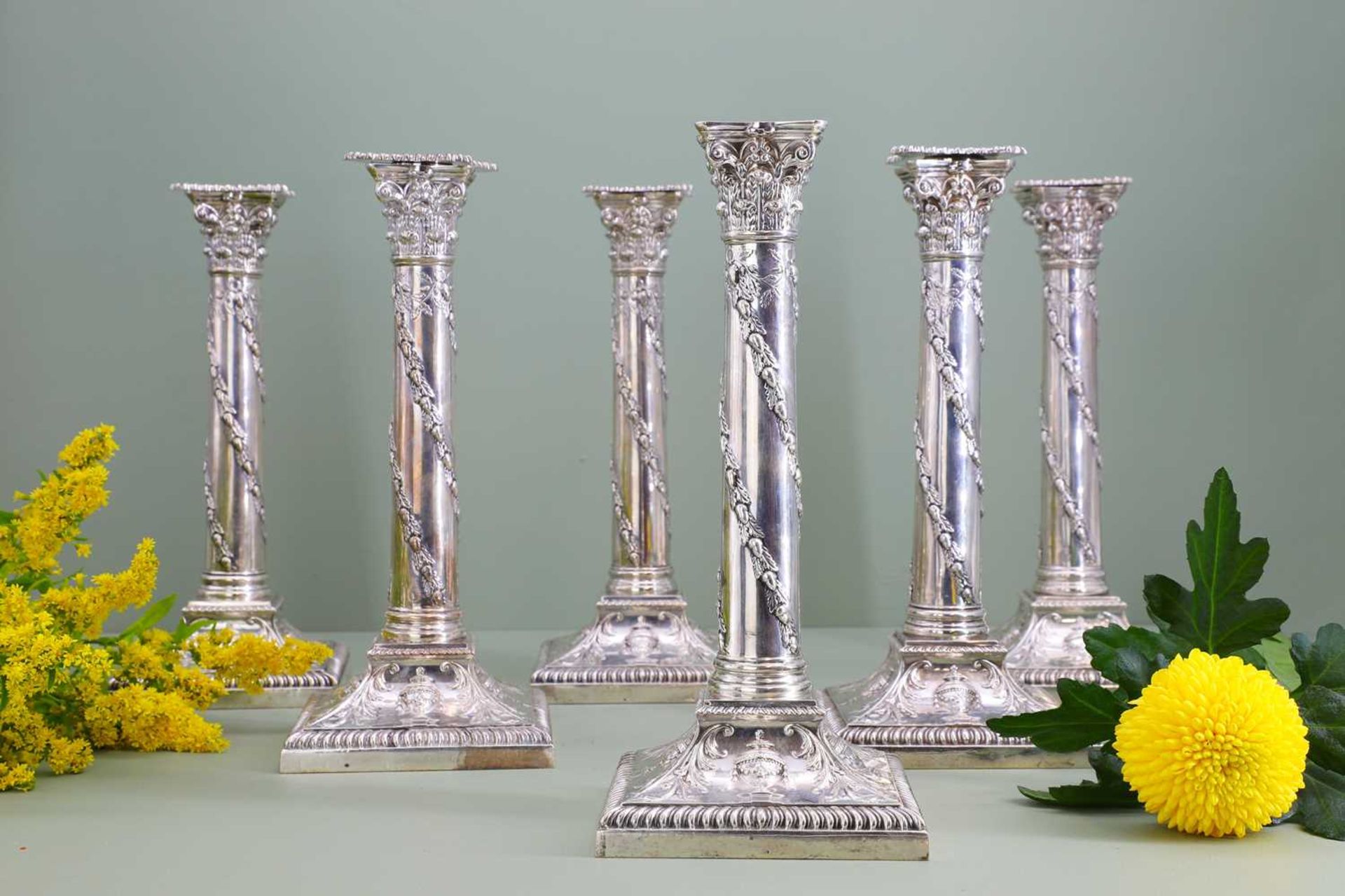 A composed set of six Edwardian silver candlesticks