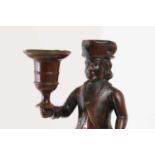 A bronze figural candlestick,