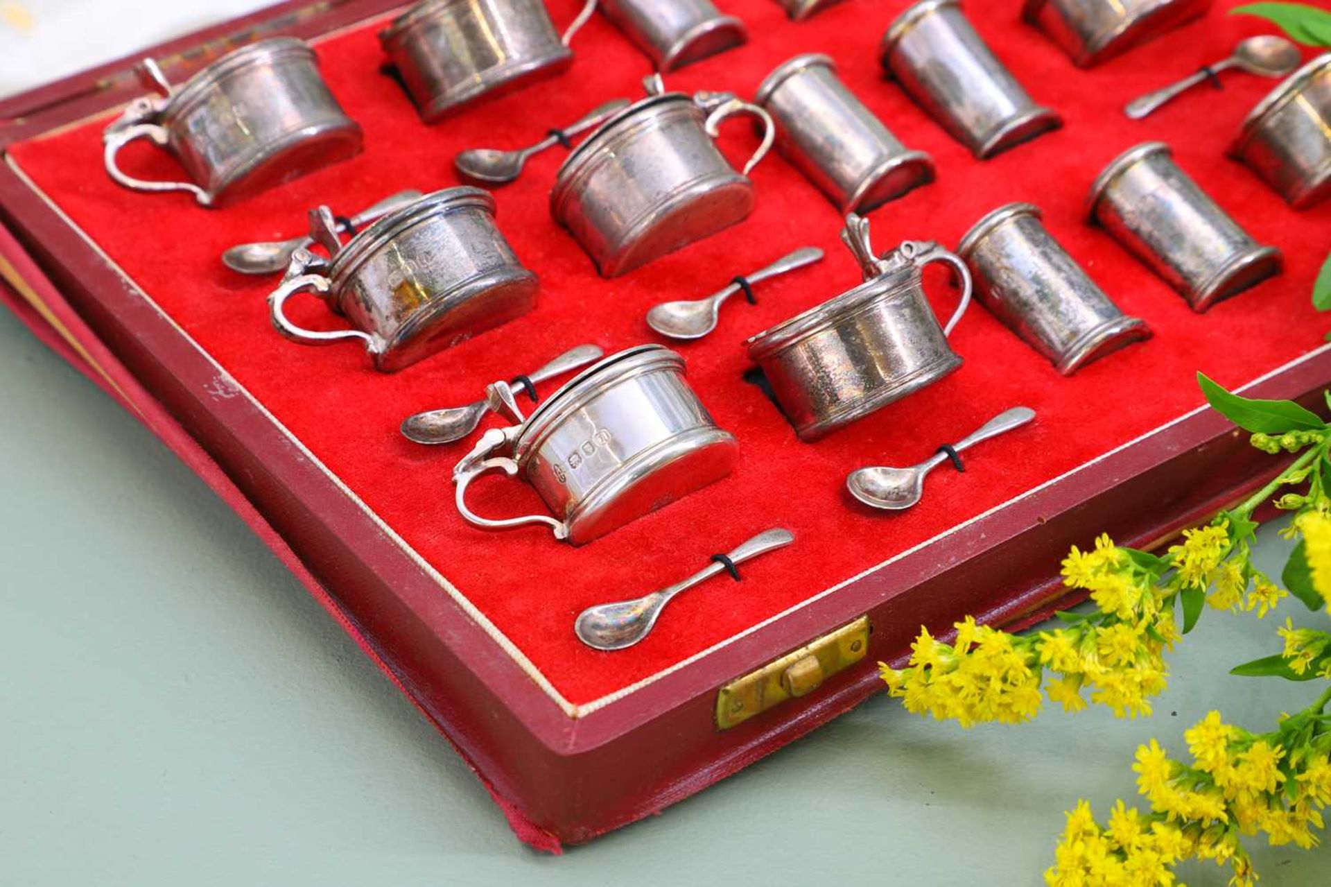 An eighteen-piece cased silver cruet set,