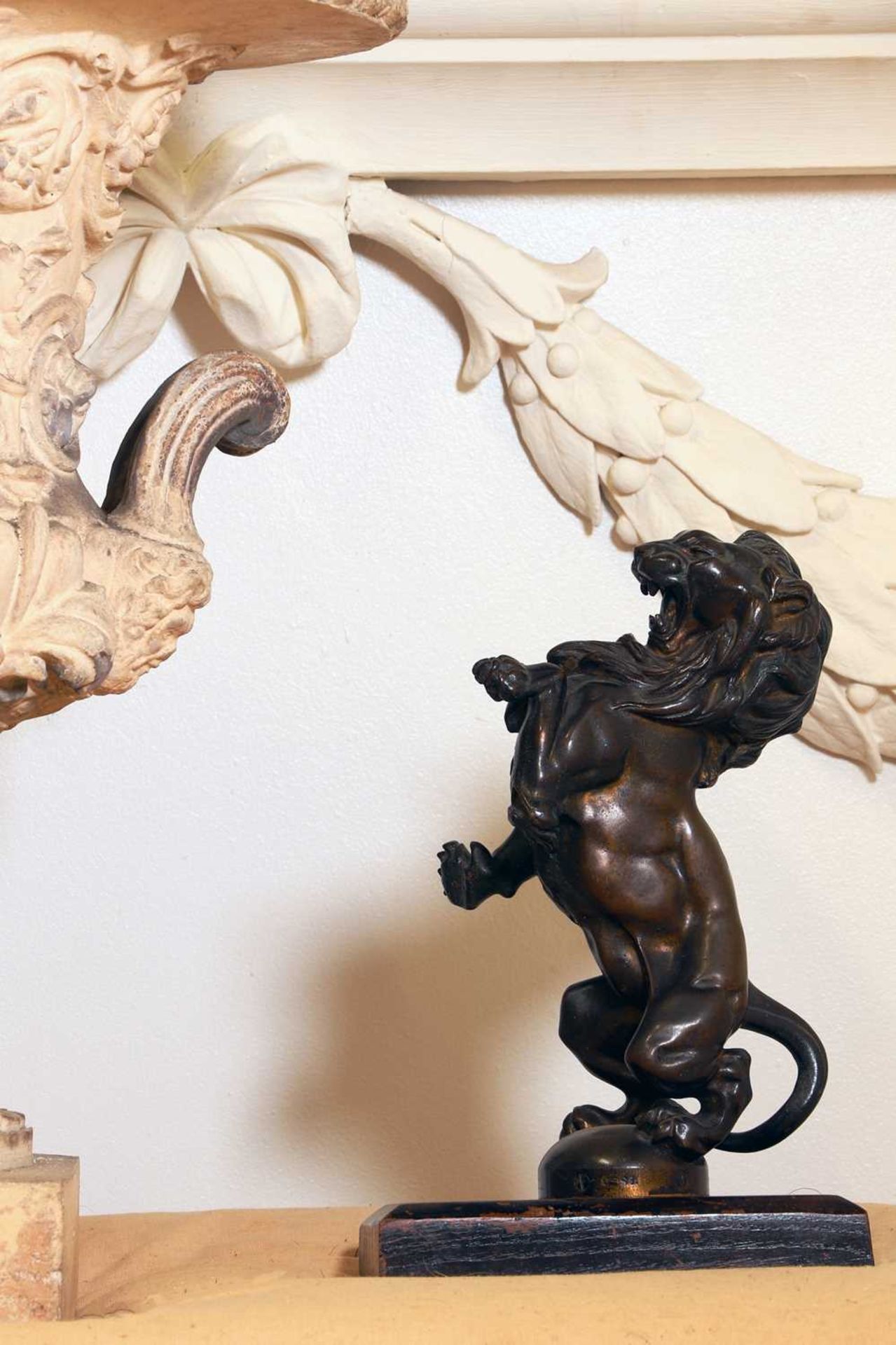 A bronze figure of a rampant lion,
