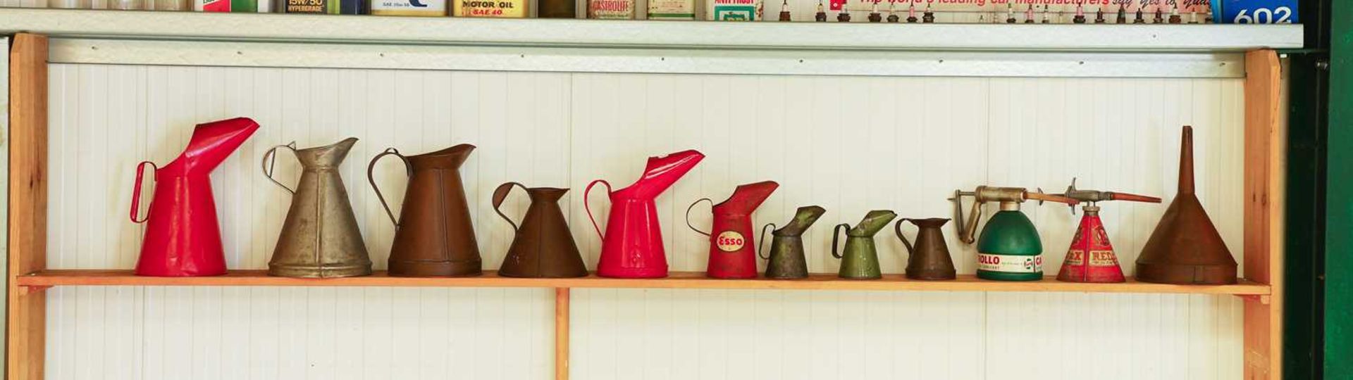 Various pre-war copper, aluminium and liveried tin oil jugs,