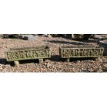 A pair of weathered composite stone troughs