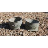 A pair of small circular lead planters