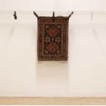 A Persian red ground prayer rug