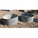 A pair of circular lead planters