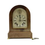 A mahogany and curved glass mantel clock
