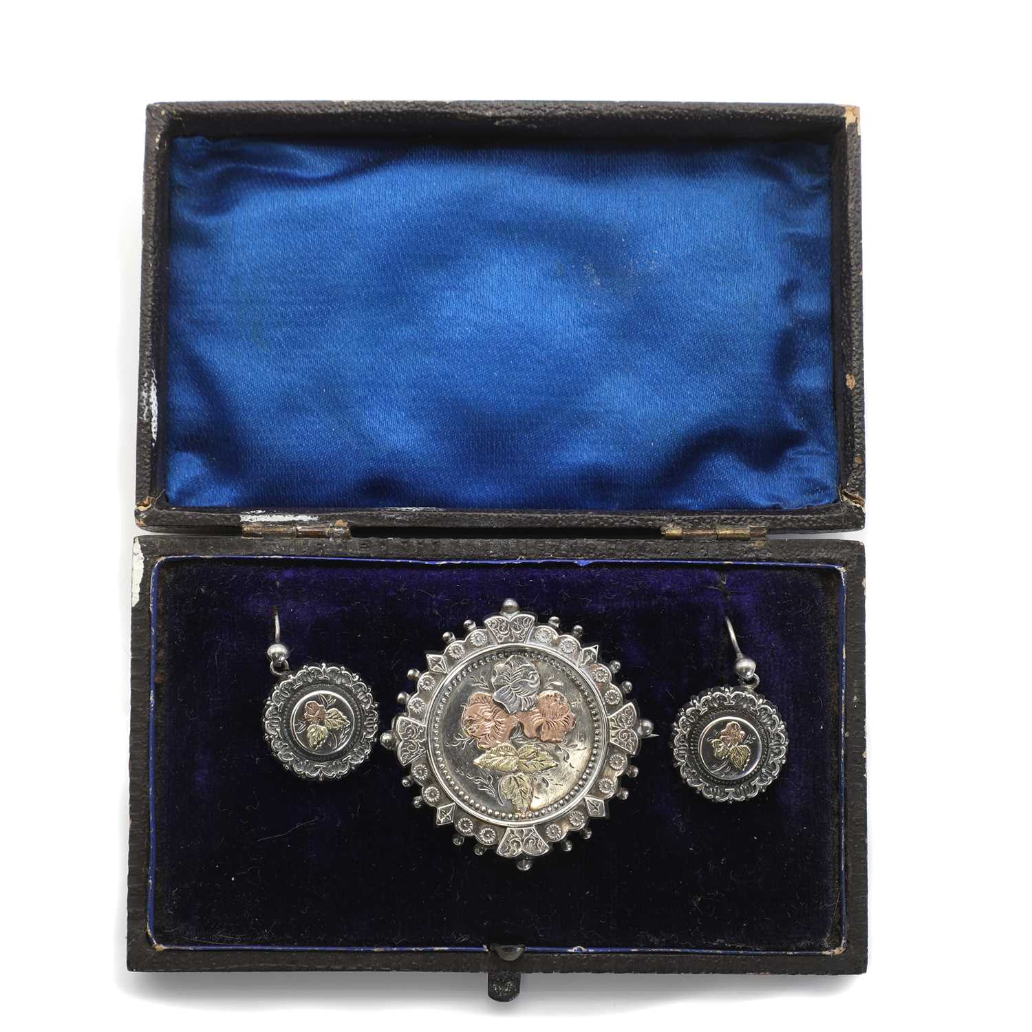 A Victorian Aesthetic Movement silver brooch and earrings suite,