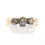 An 18ct gold three stone diamond ring,