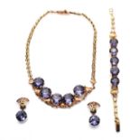 A gold and synthetic colour change sapphire jewellery suite,