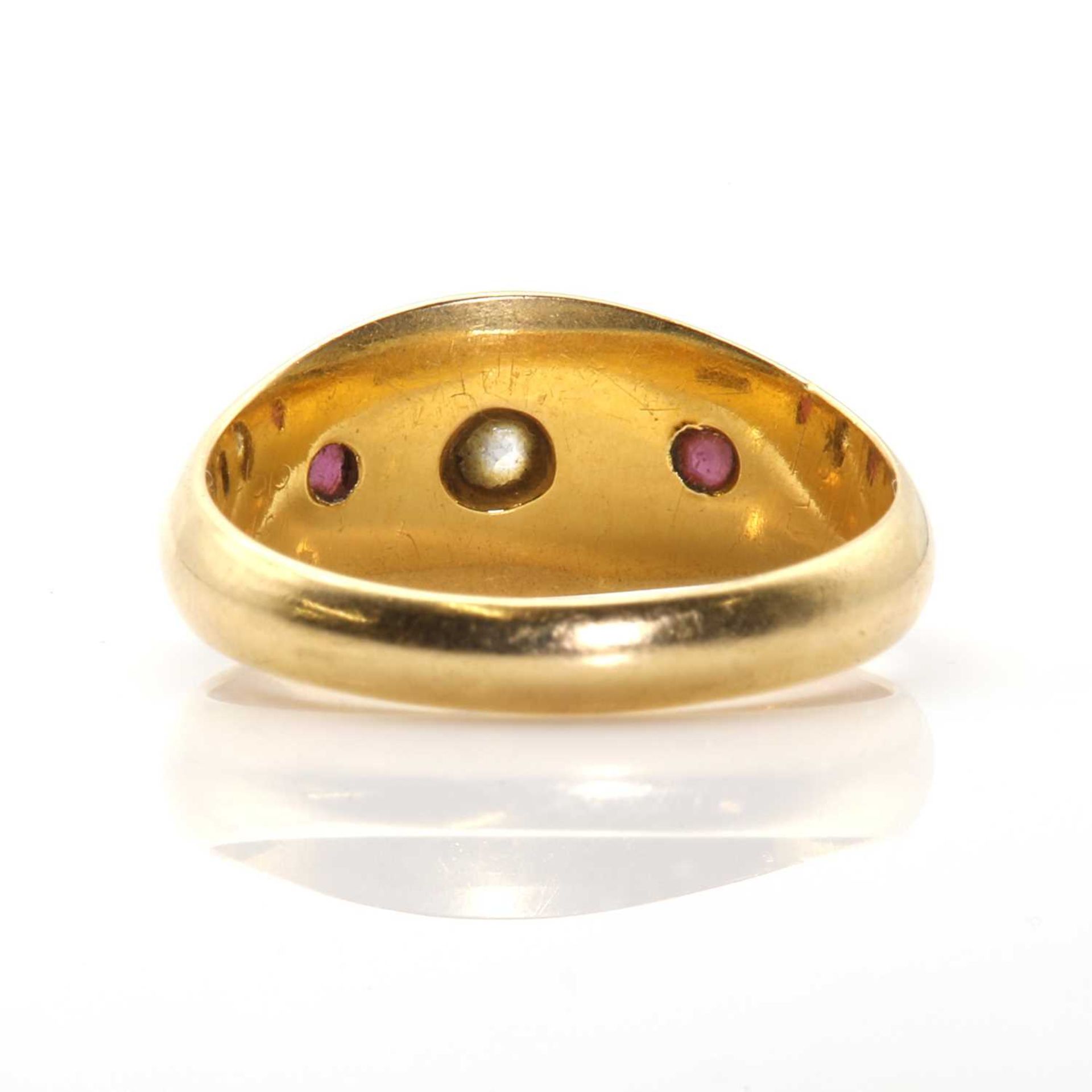 An 18ct gold diamond and garnet three stone ring, - Image 3 of 3