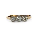 A gold three stone diamond ring,