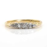 A gold five stone diamond carved head ring,
