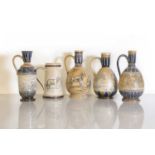 A collection of five Doulton Lambeth stoneware ewers,