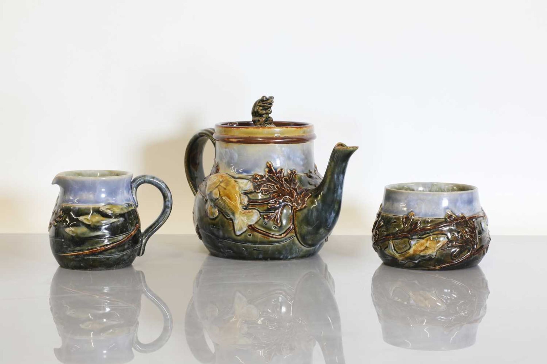 A Royal Doulton stoneware three-piece tea set,