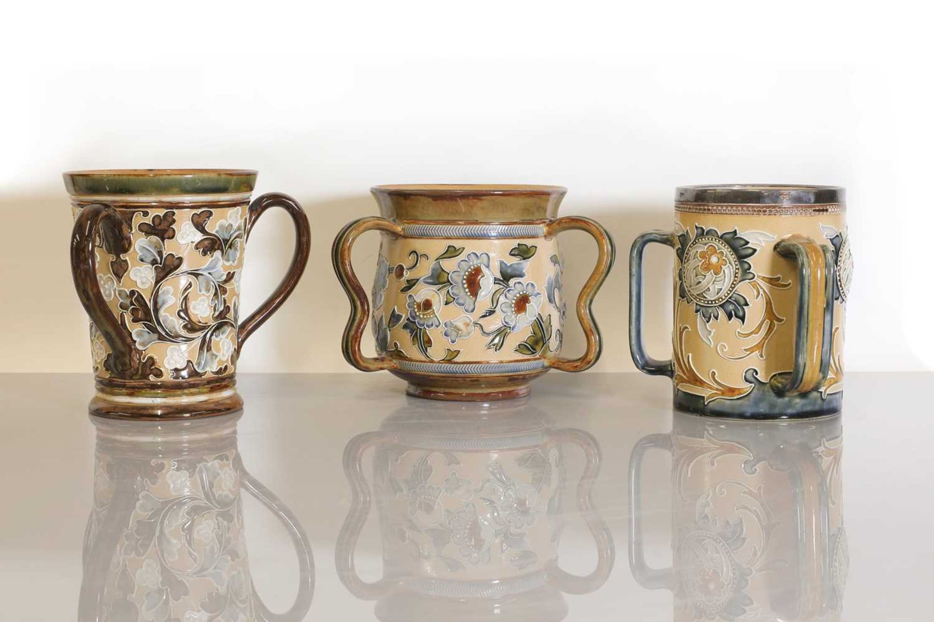 Three Doulton Lambeth stoneware loving cups,