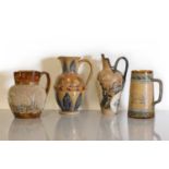 Four Doulton Lambeth stoneware jugs and ewers,