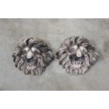 A pair of French stoneware lion's head masks,