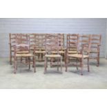 A rare group of thirteen Heal's limed oak ladder-back dining chairs,